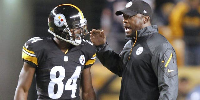 Sep 22, 2013; Pittsburgh, PA, USA; Pittsburgh Steelers wide receiver Antonio Brown (84) and Steelers head coach Mike Tomlin talk before playing the Chicago Bears at Heinz Field. Mandatory Credit: Charles LeClaire-USA TODAY Sports