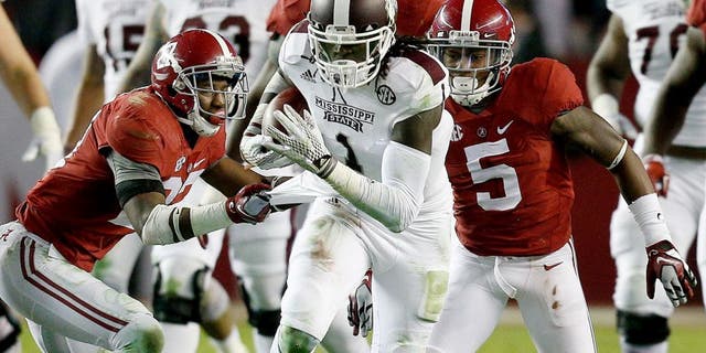Nov 15, 2014; Tuscaloosa, AL, USA; Mississippi State Bulldogs wide receiver De'Runnya Wilson (1) is grabbed from behind by Alabama Crimson Tide defensive back Nick Perry (27) at Bryant-Denny Stadium. Mandatory Credit: Marvin Gentry-USA TODAY Sports