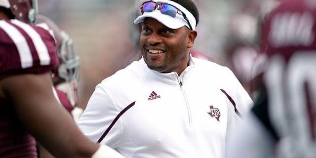 Nov 9, 2013; College Station, TX, USA; Texas A&M Aggies head coach Kevin Sumlin coaches before the game against the Mississippi State Bulldogs at Kyle Field. Mandatory Credit: Thomas Campbell-USA TODAY Sports