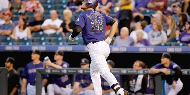 DENVER, CO - SEPTEMBER 02: Nolan Arenado #28 of the Colorado Rockies watches his two run home run off of Chase Anderson #57 of the Arizona Diamondbacks to give the Rockies a 3-1 lead in the first inning at Coors Field on September 2, 2015 in Denver, Colorado. (Photo by Doug Pensinger/Getty Images)