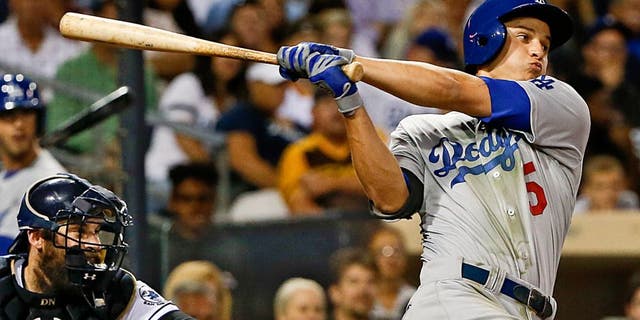 Los Angeles Dodgers' Corey Seager follows through with his second hit in his major league debut, during the sixth inning of a baseball game against the San Diego Padres on Thursday, Sept. 3, 2015, in San Diego. (AP Photo/Lenny Ignelzi)
