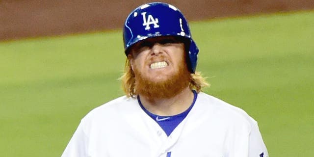 LOS ANGELES, CA - SEPTEMBER 02: Justin Turner #10 of the Los Angeles Dodgers grimaces after he is hit by a pitch during the fourth inning against the San Francisco Giants at Dodger Stadium on September 2, 2015 in Los Angeles, California. (Photo by Harry How/Getty Images)