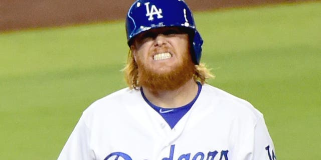 LOS ANGELES, CA - SEPTEMBER 02: Justin Turner #10 of the Los Angeles Dodgers grimaces after he is hit by a pitch during the fourth inning against the San Francisco Giants at Dodger Stadium on September 2, 2015 in Los Angeles, California. (Photo by Harry How/Getty Images)