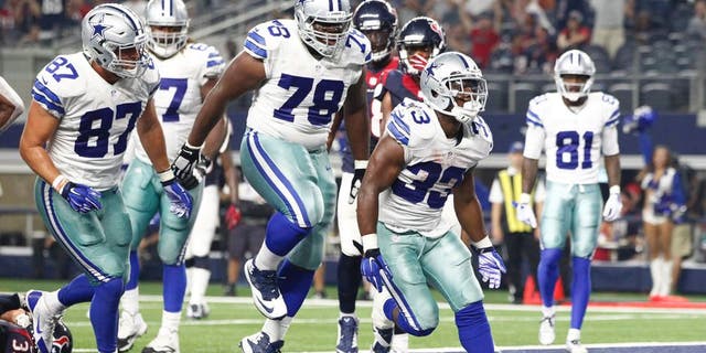 Sep 3, 2015; Arlington, TX, USA; Dallas Cowboys running back Ben Malena (33) celebrates scoring a touchdown in the fourth quarter against the Houston Texans at AT&T Stadium. Dallas won 21-14. Mandatory Credit: Tim Heitman-USA TODAY Sports