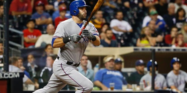 Texas Rangers' Mitch Moreland watches his run producing double just stay fair down the right field line in the tenth inning of a baseball game against the San Diego Padres Wednesday, Sept. 2, 2015, in San Diego. (AP Photo/Lenny Ignelzi)