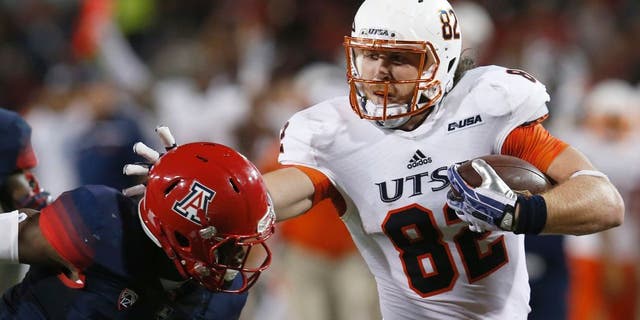 UTSA tight end David Morgan II (82) stiff arms Arizona safety Will Parks during the first half of an NCAA college football game, Thursday, Sept. 3, 2015, in Tucson, Ariz. (AP Photo/Rick Scuteri)