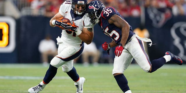 Aug 22, 2015; Houston, TX, USA; Denver Broncos tight end Owen Daniels (81) is tackled after a reception by Houston Texans safety Eddie Pleasant (35) at NRG Stadium. Mandatory Credit: Matthew Emmons-USA TODAY Sports