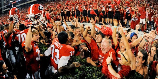 Aug 30, 2014; Athens, GA, USA; Georgia Bulldogs players and fans react after defeating the Clemson Tigers at Sanford Stadium. Georgia defeated Clemson 45-21. Mandatory Credit: Dale Zanine-USA TODAY Sports