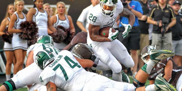 Sep 4, 2015; Kalamazoo, MI, USA; Michigan State Spartans running back Madre London (28) runs the ball against the Western Michigan Broncos prior to a game at Waldo Stadium. Mandatory Credit: Mike Carter-USA TODAY Sports
