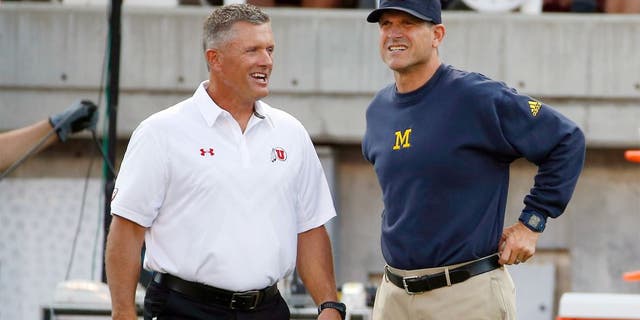 Sep 3, 2015; Salt Lake City, UT, USA; Utah Utes head coach Kyle Whittingham (left) and Michigan Wolverines head coach Jim Harbaugh get together prior to their game at Rice-Eccles Stadium. Mandatory Credit: Jeff Swinger-USA TODAY Sports