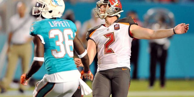 Sep 3, 2015; Miami Gardens, FL, USA; Tampa Bay Buccaneers kicker Kyle Brindza (2) kicks a field goal as Miami Dolphins defensive back Tony Lippett (36) looks on during the first half at Sun Life Stadium. Mandatory Credit: Steve Mitchell-USA TODAY Sports