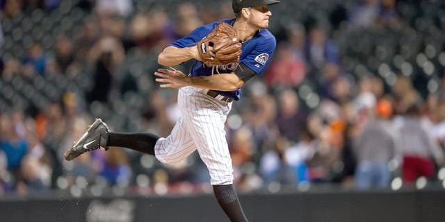 DENVER, CO - SEPTEMBER 3: Chris Rusin #52 of the Colorado Rockies pitches against the San Francisco Giants in the ninth inning during a game at Coors Field on September 3, 2015 in Denver, Colorado. Rusin pitched a complete game allowing 6 hits and 2 runs. (Photo by Dustin Bradford/Getty Images)