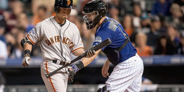 DENVER, CO - SEPTEMBER 3: Nori Aoki #23 of the San Francisco Giants is tagged out by Nick Hundley #4 of the Colorado Rockies after striking out in a fifth inning pinch hit appearance during a game at Coors Field on September 3, 2015 in Denver, Colorado. (Photo by Dustin Bradford/Getty Images)