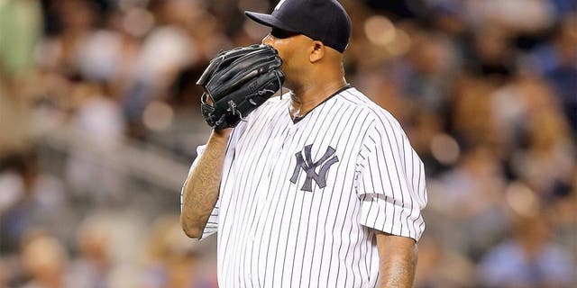 NEW YORK, NY - AUGUST 18: CC Sabathia #52 of the New York Yankees reacts after Miguel Sano of the Minnesota Twins hit a two run home run in the seventh inning on August 18, 2015 at Yankee Stadium in the Bronx borough of New York City. (Photo by Elsa/Getty Images)