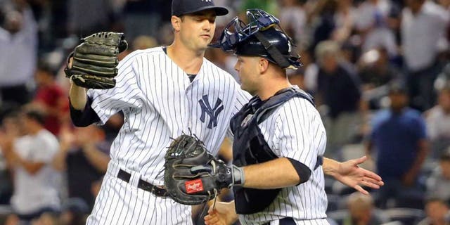 Sep 4, 2015; Bronx, NY, USA; New York Yankees relief pitcher Andrew Miller (48) and catcher Brian McCann (34) celebrate the win against the Tampa Bay Rays at Yankee Stadium. New York Yankees won 5-2. Mandatory Credit: Anthony Gruppuso-USA TODAY Sports