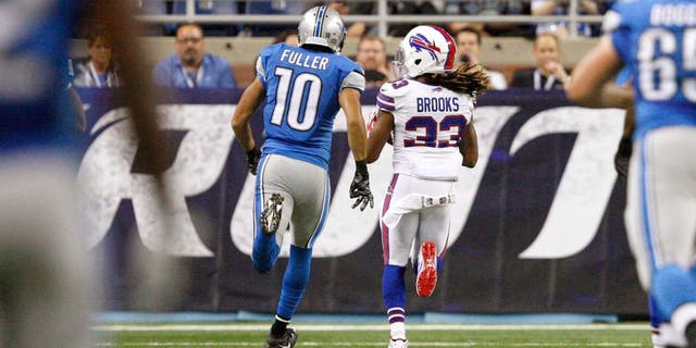 Sep 3, 2015; Detroit, MI, USA; Buffalo Bills cornerback Ron Brooks (33) makes an interception for a touchdown and is chased by Detroit Lions wide receiver Corey Fuller (10) during the first quarter of a preseason NFL football game at Ford Field. Mandatory Credit: Raj Mehta-USA TODAY Sports