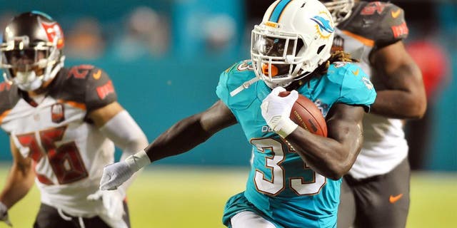 Sep 3, 2015; Miami Gardens, FL, USA; Miami Dolphins running back Jay Ajayi (33) runs against the Tampa Bay Buccaneers during the first half at Sun Life Stadium. Mandatory Credit: Steve Mitchell-USA TODAY Sports