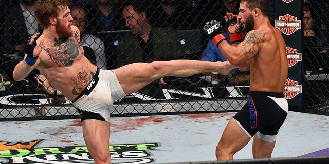 LAS VEGAS, NV - JULY 11: (L-R) Conor McGregor kicks Chad Mendes during the UFC 189 event inside MGM Grand Garden Arena on July 11, 2015 in Las Vegas, Nevada. (Photo by Jeff Bottari/Zuffa LLC/Zuffa LLC via Getty Images)