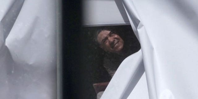 Sept. 6: A man believed to have strapped what appeared to be a bomb to himself looks out of a window next to the Parramatta court building near Sydney.