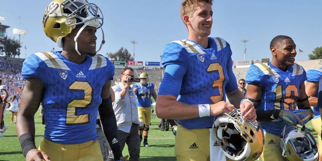 September 5, 2015; Pasadena, CA, USA; UCLA Bruins quarterback Josh Rosen (3), wide receiver Jordan Lasley (2) and defensive back Octavius Spencer (18) following the 34-16 victory against the Virginia Cavaliers at the Rose Bowl. Mandatory Credit: Gary A. Vasquez-USA TODAY Sports