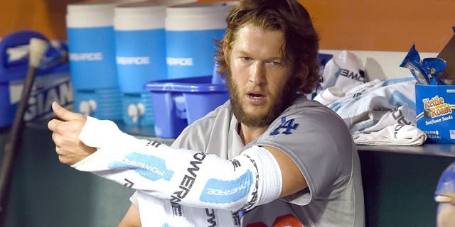 SAN FRANCISCO, CA - SEPTEMBER 29: Clayton Kershaw #22 of the Los Angeles Dodgers wraps his pitching arm up with towels to keep it warm while sitting in the dugout in the top of the ninth inning against the San Francisco Giants at AT&T Park on September 29, 2015 in San Francisco, California. (Photo by Thearon W. Henderson/Getty Images)