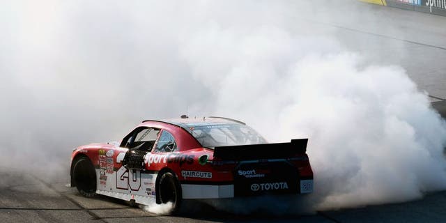 DARLINGTON, SC - SEPTEMBER 05: Denny Hamlin, driver of the #20 Sport Clips Toyota, celebrates with a burnout after winning the NASCAR XFINITY Series VFW Sport Clips Help A Hero 200 at Darlington Raceway on September 5, 2015 in Darlington, South Carolina. (Photo by Robert Laberge/NASCAR via Getty Images)