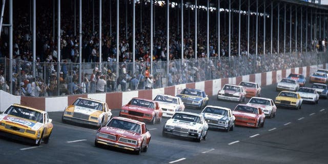 DARLINGTON, SC - APRIL 10, 1983: Darrell Waltrip (No. 11) pulls ahead of pole sitter Tim Richmond (No. 27) as the field heads toward turn one at the start of the TranSouth 500 at Darlington Raceway. (Photo by ISC Images & Archives via Getty Images)