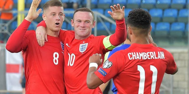 England's midfielder Ross Barkley (L) celebrates with England's forward Wayne Rooney (C) and England's forward Alex Oxlade Chamberlain after scoring during the EURO 2016 qualifying football match San Marino vs England at the San Marino stadium in Serravalle on September 5, 2015. AFP PHOTO / VINCENZO PINTO (Photo credit should read VINCENZO PINTO/AFP/Getty Images)