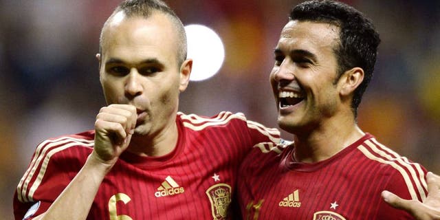 Spain's midfielder Andres Iniesta (L) celebrates with Spain's forward Pedro Rodriguez after scoring a goal during the Euro 2016 qualifying football match Spain vs Slovakia at the Carlos Tartiere stadium in Oviedo on September 5, 2015. AFP PHOTO/ MIGUEL RIOPA (Photo credit should read MIGUEL RIOPA/AFP/Getty Images)