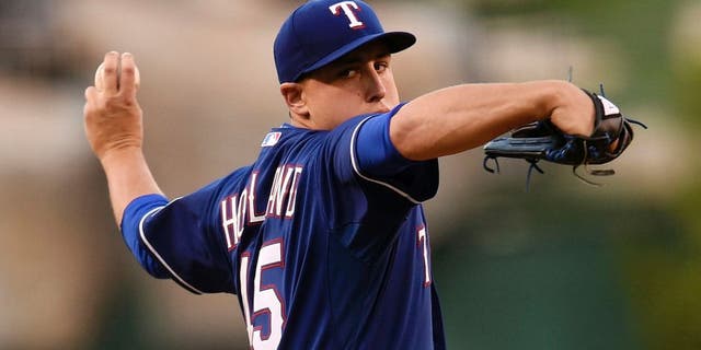 Sep 5, 2015; Anaheim, CA, USA; Texas Rangers starting pitcher Derek Holland (45) pitches against the Los Angeles Angels during the first inning at Angel Stadium of Anaheim. Mandatory Credit: Kelvin Kuo-USA TODAY Sports