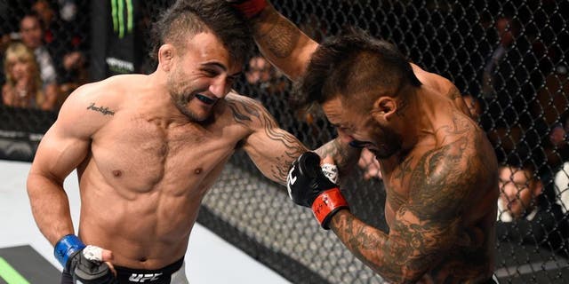 LAS VEGAS, NV - SEPTEMBER 05: (L-R) John Lineker punches Francisco Rivera in their bantamweight bout during the UFC 191 event inside MGM Grand Garden Arena on September 5, 2015 in Las Vegas, Nevada. (Photo by Jeff Bottari/Zuffa LLC/Zuffa LLC via Getty Images)