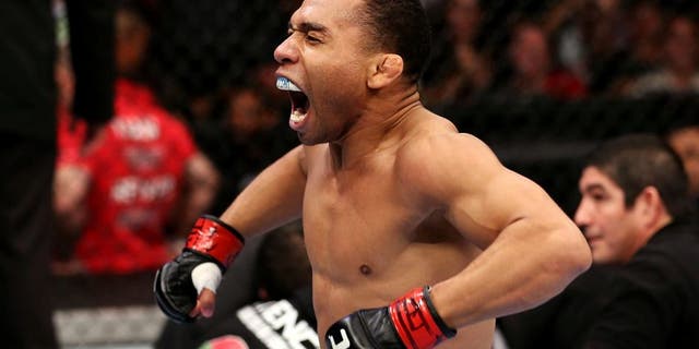 HOUSTON, TEXAS - OCTOBER 19: (L-R) John Dodson celebrates after defeating Darrell Montague by knockout in their UFC flyweight bout at the Toyota Center on October 19, 2013 in Houston, Texas. (Photo by Nick Laham/Zuffa LLC/Zuffa LLC via Getty Images)