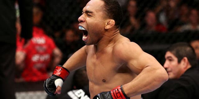 HOUSTON, TEXAS - OCTOBER 19: (L-R) John Dodson celebrates after defeating Darrell Montague by knockout in their UFC flyweight bout at the Toyota Center on October 19, 2013 in Houston, Texas. (Photo by Nick Laham/Zuffa LLC/Zuffa LLC via Getty Images)