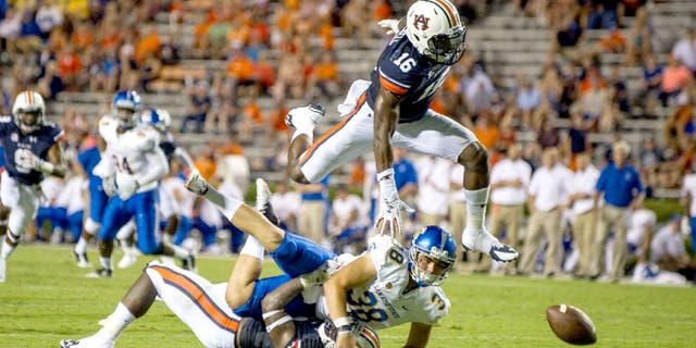 AUBURN, AL - SEPTEMBER 6: Linebacker JaViere Mitchell #16 of the Auburn Tigers leaps over linebacker Tre' Williams #30 of the Auburn Tigers and place kicker Michael Carrizosa #38 of the San Jose State Spartans to attempt to recover a fumble on September 6, 2014 at Jordan-Hare Stadium in Auburn, Alabama. Auburn defeated San Jose State 59-13. (Photo by Michael Chang/Getty Images)