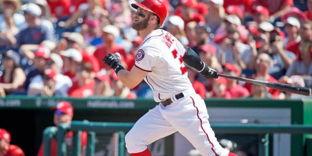 Washington Nationals' Bryce Harper watches his solo home run during the third inning of a baseball game against the Atlanta Braves at Nationals Park, Sunday, Sept. 6, 2015, in Washington. (AP Photo/Alex Brandon)