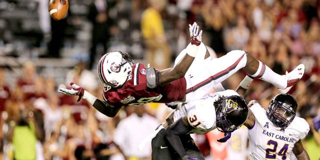 Sep 6, 2014; Columbia, SC, USA; South Carolina Gamecocks tight end Jerell Adams (89) is upended going for the reception by East Carolina Pirates defensive back Domonique Lennon (31) during game action between the South Carolina Gamecocks and East Carolina Pirates at Williams-Brice Stadium. Mandatory Credit: Jim Dedmon-USA TODAY Sports