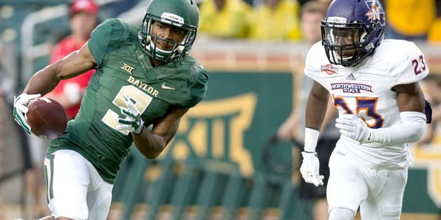 Sep 6, 2014; Waco, TX, USA; Baylor Bears wide receiver KD Cannon (9) catches a pass for a touchdown as Northwestern State Demons cornerback Fred Thomas (23) defends during the first quarter at McLane Stadium. Mandatory Credit: Jerome Miron-USA TODAY Sports