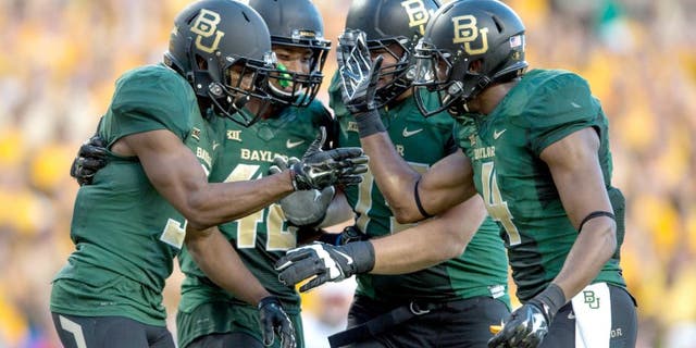Aug 31, 2014; Waco, TX, USA; Baylor Bears wide receiver KD Cannon (9) and running back Levi Norwood (42) and wide receiver Jay Lee (4) celebrate Cannons touchdown against the Southern Methodist Mustangs during the first half at McLane Stadium. Mandatory Credit: Jerome Miron-USA TODAY Sports