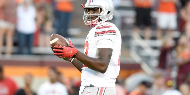 Sep 7, 2015; Blacksburg, VA, USA; Ohio State Buckeyes quarterback Cardale Jones (12) with the ball at Lane Stadium. Mandatory Credit: Bob Donnan-USA TODAY Sports