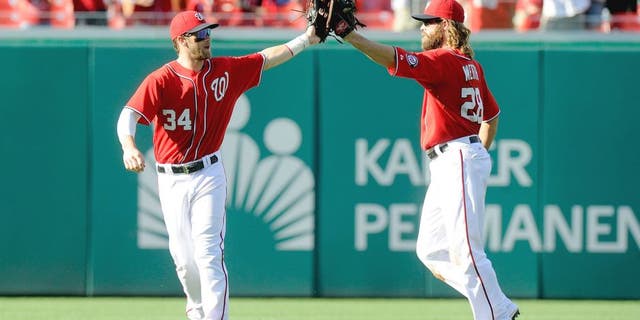 WASHINGTON, DC - AUGUST 24: Bryce Harper #34 of the Washington Nationals celebrates with Jayson Werth #28 after a victory against the San Francisco Giants at Nationals Park on August 24, 2014 in Washington, DC. (Photo by G Fiume/Getty Images)