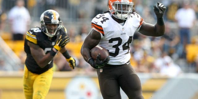 Sep 7, 2014; Pittsburgh, PA, USA; Cleveland Browns running back Isaiah Crowell (34) runs the ball past Pittsburgh Steelers linebacker Ryan Shazier (50) during the second half at Heinz Field. Pittsburgh won the game, 30-27. Mandatory Credit: Jason Bridge-USA TODAY Sports