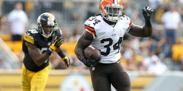 Sep 7, 2014; Pittsburgh, PA, USA; Cleveland Browns running back Isaiah Crowell (34) runs the ball past Pittsburgh Steelers linebacker Ryan Shazier (50) during the second half at Heinz Field. Pittsburgh won the game, 30-27. Mandatory Credit: Jason Bridge-USA TODAY Sports