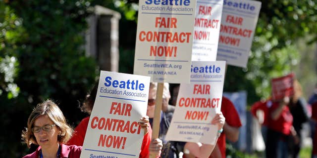 SEpt. 2, 2015: About 50 teachers picket and chant as they picket outside West Seattle High School in Seattle.