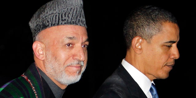 March 28: President Obama walks with Afghan President Hamid Karzai at the presidential palace in Kabul, Afghanistan.