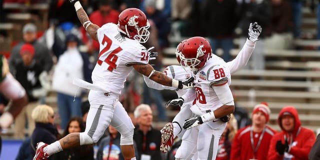 Dec 21, 2013; Albuquerque, NM, USA; Washington State Cougars wide receiver Isiah Myers (88) is congratulated by teammate Theron West (24) after a second half touchdown against the Colorado State Rams during the Gildan New Mexico Bowl at University Stadium. The Rams defeated the Cougars 48-45. Mandatory Credit: Mark J. Rebilas-USA TODAY Sports