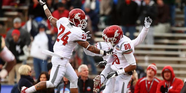 Dec 21, 2013; Albuquerque, NM, USA; Washington State Cougars wide receiver Isiah Myers (88) is congratulated by teammate Theron West (24) after a second half touchdown against the Colorado State Rams during the Gildan New Mexico Bowl at University Stadium. The Rams defeated the Cougars 48-45. Mandatory Credit: Mark J. Rebilas-USA TODAY Sports