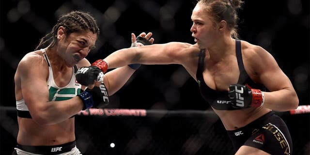 RIO DE JANEIRO, BRAZIL - AUGUST 01: Ronda Rousey of the United States punches Bethe Correia of Brazil in their bantamweight title fight during the UFC 190 Rousey v Correia at HSBC Arena on August 1, 2015 in Rio de Janeiro, Brazil. (Photo by Buda Mendes/Zuffa LLC/Zuffa LLC via Getty Images)