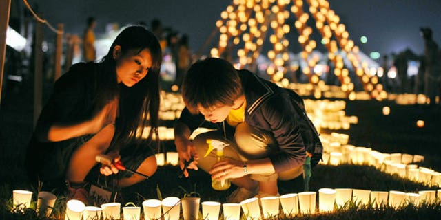 Sept. 11: Local residents light a candle at a park during a memorial event marking six months after the March 11 earthquake and tsunami in Iwanuma city, Miyagi prefecture.