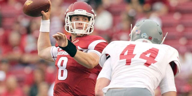 Sep 6, 2014; Fayetteville, AR, USA; Arkansas Razorbacks quarterback Austin Allen (8) looks to pass defended by Nicholls State Colonels linebacker John Williamson (44) at Donald W. Reynolds Razorback Stadium. Arkansas defeated Nicholls State 73-7. Mandatory Credit: Nelson Chenault-USA TODAY Sports