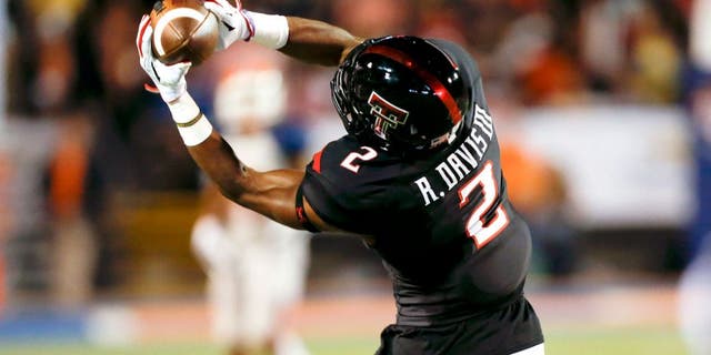 Sep 6, 2014; El Paso, TX, USA; Texas Tech Red Raiders wide receiver Reginald Davis (2) catches a ball against the UTEP Miners defense at Sun Bowl Stadium. Mandatory Credit: Ivan Pierre Aguirre-USA TODAY Sports